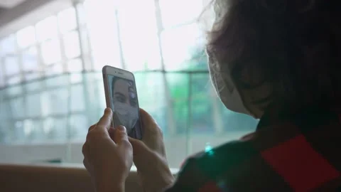 Back view close up of two girlfriends in protective masks talking online on Stock Footage 141519945