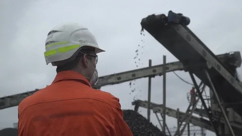 A back view of a coal miner observing coal mining process Video stock 101505487