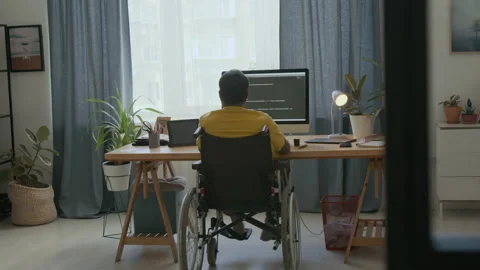 Back view of coder in wheelchair developing app on computer Stockbeeldmateriaal 286201475
