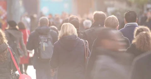 Back view of commuters walking to go to work in a business district Stock Footage 92250950