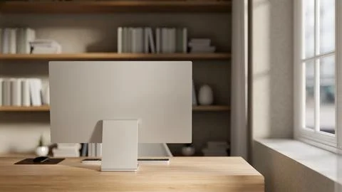 A back view of a computer set up on a minimalist wooden desk by the window .. Stock Illustration