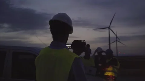 Back view of concentrated man engineer standing at sunset in wind power plant Stock Footage 256091967