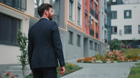 Back view confident guy in suit going along city street successful businessman Stock Footage 214508926