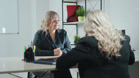 Back view of consultant talking to focused client during office consultation Видео 310811412