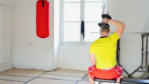 Back view with copy space of caucasian man doing triceps exercises using Stock-Footage 153784321