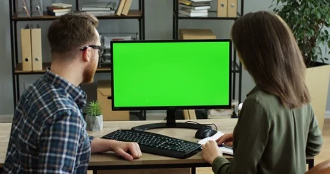 Back view on the couple of co-workers sitting in the office at the table and Stock Footage 89950883