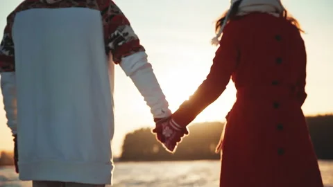 Back view of couple holding hands wearin... | Stock Video | Pond5