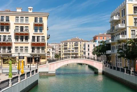 Back View of Couple Holding Hands on Arched Bridge at Qanat Quartier, Doha Stock Photos
