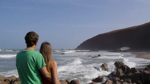 Back view of a couple hugging and watching the sea on the beach legzira 스톡 동영상 61692840