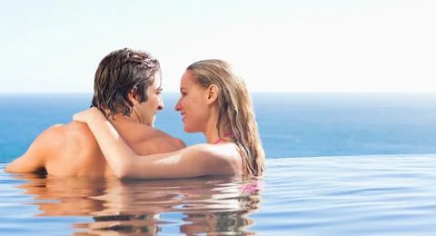 Back view of couple in the pool Stock Photos