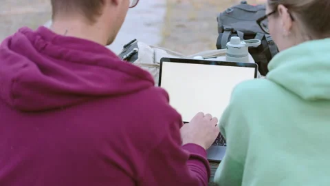Back View of a Couple Using Laptop Together at a Campsite, typing some Video stock 265640958
