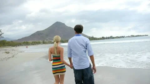 Back view of couple walking in the beach Stock Footage 14827805