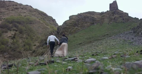 Back view. Couple walking on the mountain range. Stock Footage 96645578