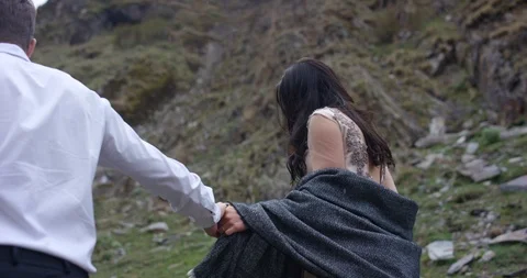Back view. Couple walking on the mountain range. Stock Footage 96645874