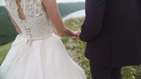 Back view. Couple walking on the mountain range near rocks. Stock Footage 233713193