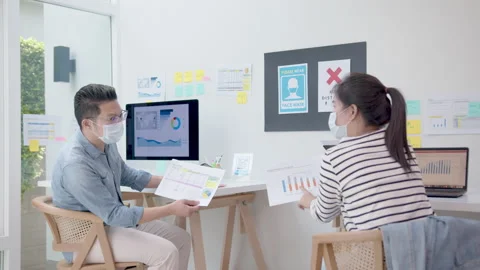 Back view of creative team staff wear face mask talking, brainstorming 스톡 동영상 140160976