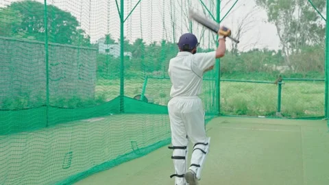 Back view of Cricket player doing warmup before the match starts in nets. Stock Footage 251644418