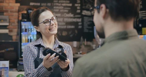 Back view of customer using credit card for payment in coffee shop Stock Footage 127158671