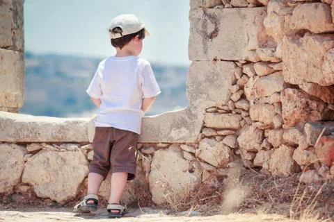 Back view of cute little boy outdoors in city Stock Photos