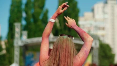 Back view of a dancing girl during the festival of colors Holi Stock Footage 231125371