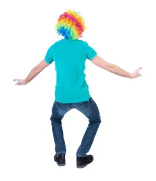 Back view of dancing young beautiful  man  in clown wig Stock Photos
