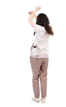 Back view of dancing young beautiful  woman. girl  watching Stock Photos