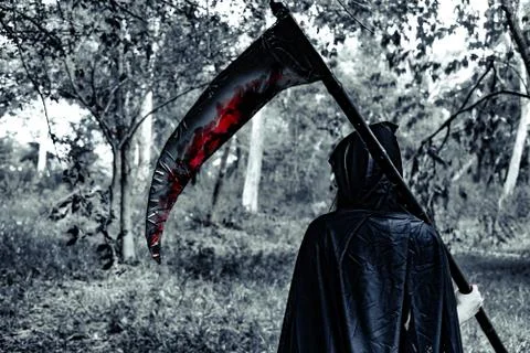 Back view of demon witch with reaper and blood in the mystery forest. Horror  Fotos de archivo