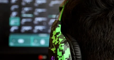 Back view of dependent gamer boy with headphone 1 Stock Footage 140916338