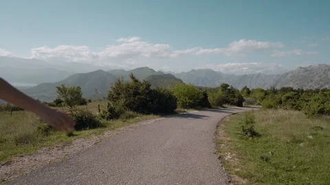 Back view of dreadlocks woman longboarding on mountain background Video stock 130782831
