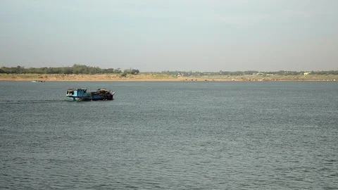 Back view on dredging boat proceeding down river to pump sand Stock Footage 102650446