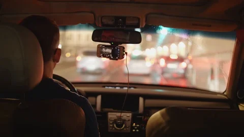 Back view of driver in car moving in traffic jam in evening city Stock Footage 106394773