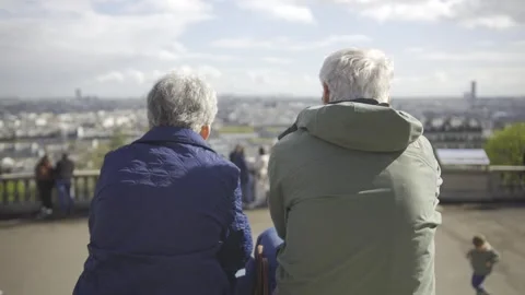 Back view of elderly couple siting together in park Stock Footage 272439811