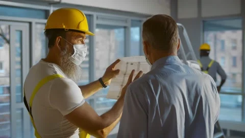 Back view of engineer and architect working on construction site and inspect Stock Footage 145970530
