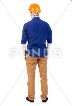 Back view of an engineer in the construction helmet stands Stock Photo ...