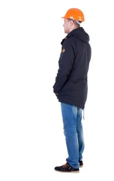 Back view of an engineer in  construction helmet stands Foto stock