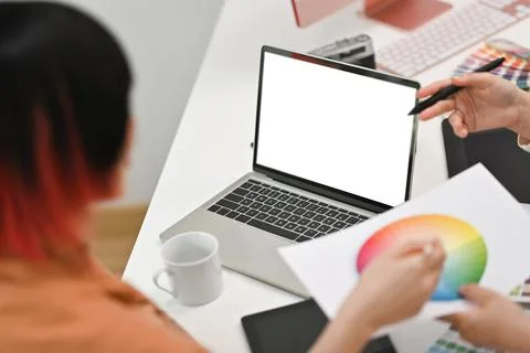 Back view of female designer working on new design project, using laptop Stock Photos