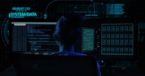 Back view of female hacker working in a dark office room Video stock 135978612