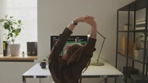 Back View of Female Programmer Stretching at Workplace Stock Footage 255782082