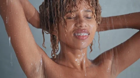 Back view female taking shower Stock Footage 253377470