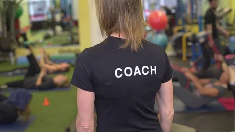 Back view of female trainer teaching class Stock Footage 73160984