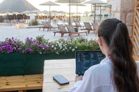 Back View of Female Web Developer Programming on Tablet at Luxury Resort Cafe Stock Photos