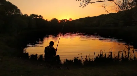 Back view of fisherman stringing bait and casting the line into pond Stock Footage 992969