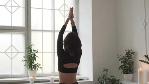 Back view of flexible young caucasian girl practice yoga in light studio room Stock Footage 148089635