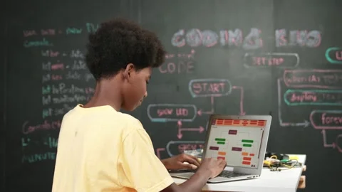Back view of frican boy programming system or coding system. Edification Stock Footage 269752757