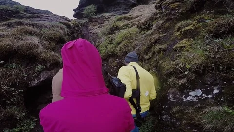 Back view of friends walking in mountains in rainy day. Group of people hiking Stock Footage