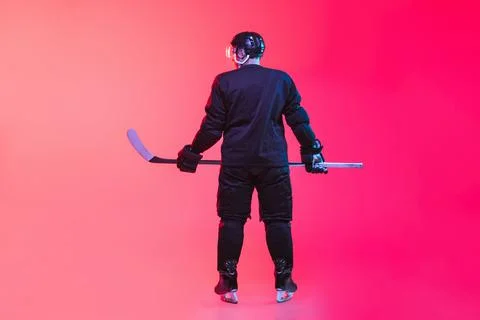 Back view full-length image of professional hockey player in uniform isolated Stock Photos