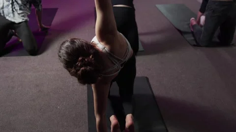 Back view of a girl doing yoga asana on a black mat Video stock 156238431