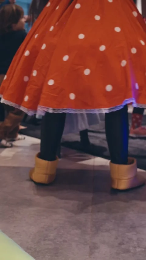 Back view of girl in Mickey Mouse costume and ears dancing at party. Stock Footage 312003626