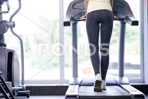 Back view of a girl on treadmill Stock Photos