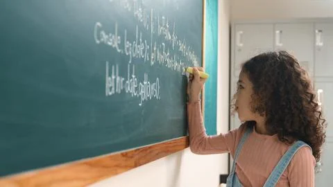 Back view of girl writing engineering prompt and programing system. Pedagogy. Stock Photos